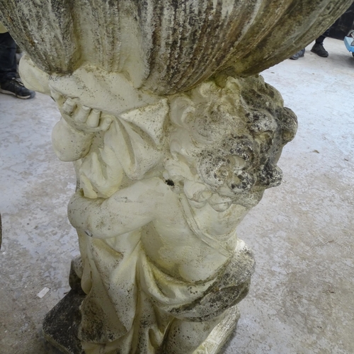 3421 - A weathered stone garden water feature, in the form of two cherubs supporting a shell. 62x100x53cm.