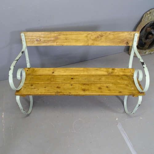 3426 - A stained pine garden bench with painted antique wrought iron ends. 122x74x62cm.