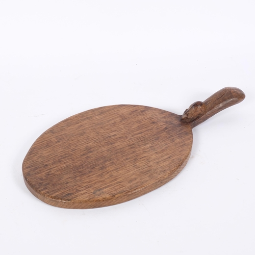 1 - ROBERT MOUSEMAN THOMPSON - an oak oval bread board, with mouse carved handle, L37.5cm