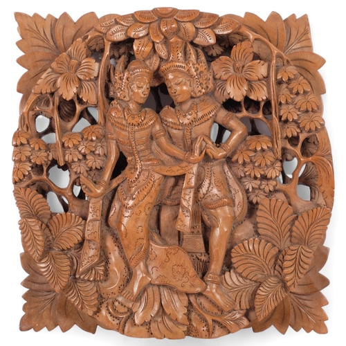 109 - An intricately carved wood Balinese Rama and Sita couple wall plaque, diameter 29cm