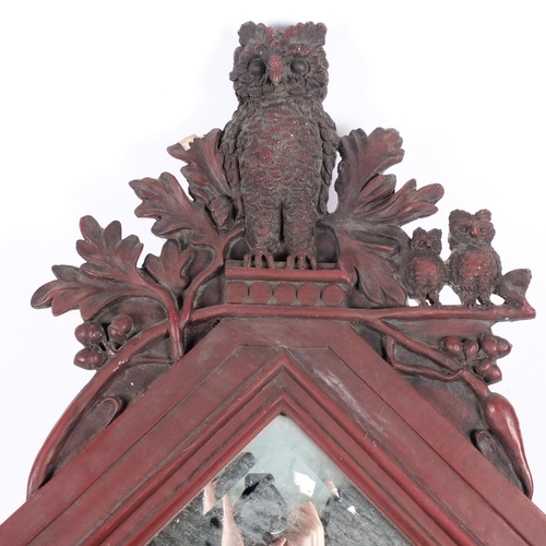 114 - A stained resin-framed lozenge wall mirror, surmounted by a family of owls, H96cm