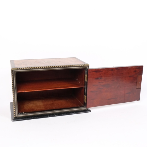 3 - A Victorian burr-walnut and brass-bound table-top box, single hinged door revealing a fitted shelf i... 