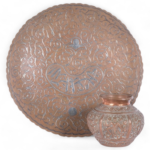 32 - A Persian silver overlay charger, diameter 25cm, together with a small Thai repousse bronze pot (2)