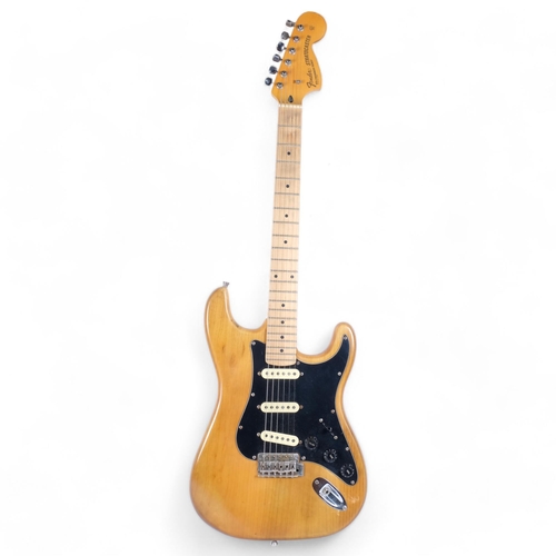 WITHDRAWN 
A 1970s Fender Stratocaster natural electric guitar, serial no. 299088, in original fitted case