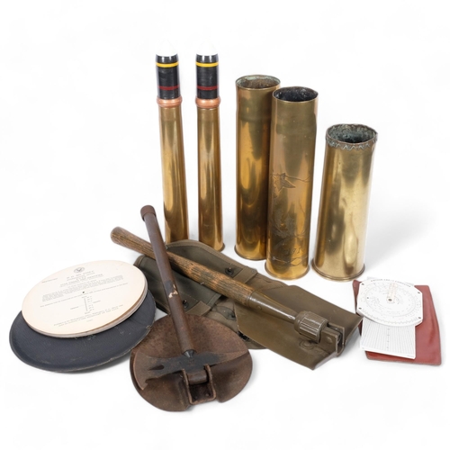 89 - 3 First World War brass shell cases, 2 Second World War brass shell cases, 2 trench spades, a hydrog... 