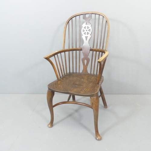 2273 - An elm-seated Windsor elbow chair, with wheelback and crinoline stretcher.