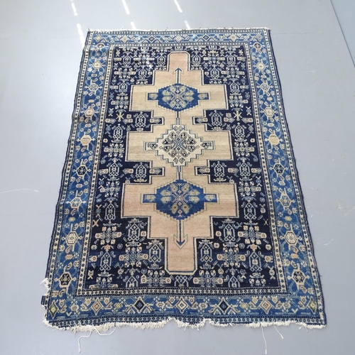 2300 - A blue ground Persian rug, 180x120cm, and a cream ground Afghan rug, 190x120cm. A/F.