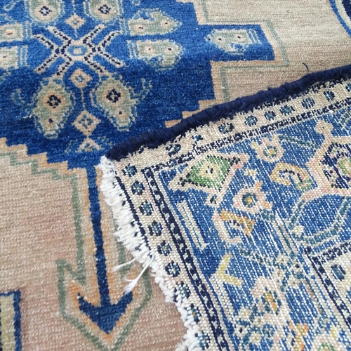 2300 - A blue ground Persian rug, 180x120cm, and a cream ground Afghan rug, 190x120cm. A/F.