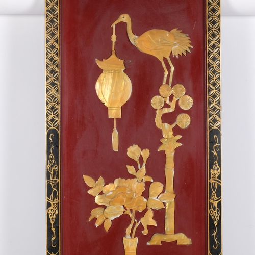 948 - A Chinese rectangular red and black lacquered panel with applied decoration, 92cm x 31cm