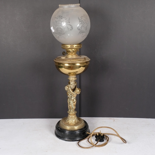 986 - Gilt-metal oil lamp converted to electric, with cherub support, H69cm