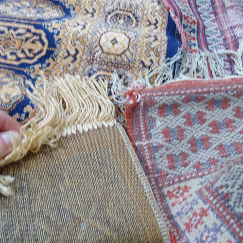 2301 - A cream ground Persian rug and an Afghan rug, a red ground Afghan rug and a part-silk Afghan mat. La... 