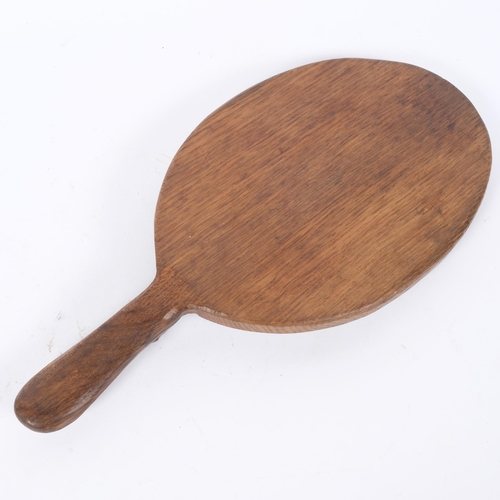 1 - ROBERT MOUSEMAN THOMPSON - an oak oval bread board, with mouse carved handle, L37.5cm