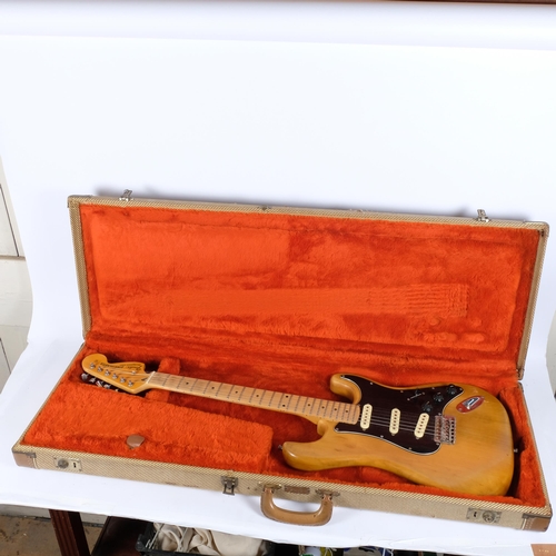 80 - WITHDRAWN 
A 1970s Fender Stratocaster natural electric guitar, serial no. 299088, in original fitte... 