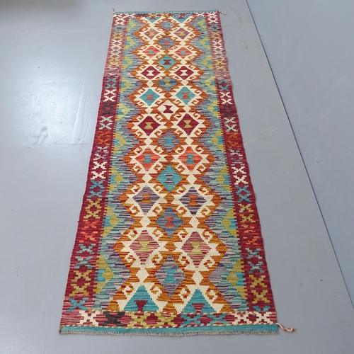 2302 - A red and teal ground chobi kilim runner, 245x84cm.