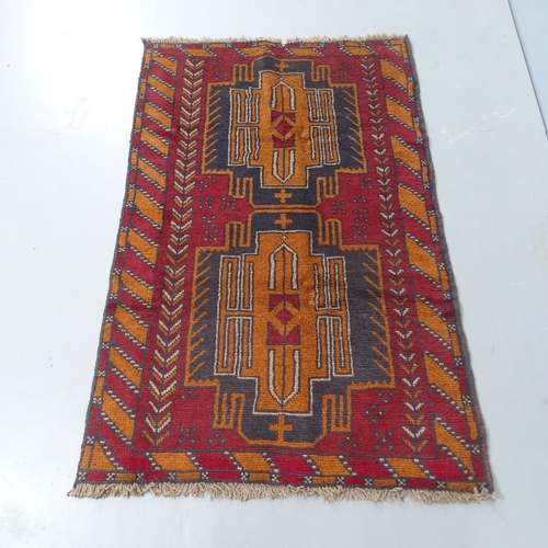 2304 - A red ground Baluchi rug, 140x87cm.