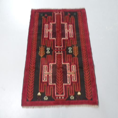 2307 - A red ground Baluchi rug, 140x85cm.