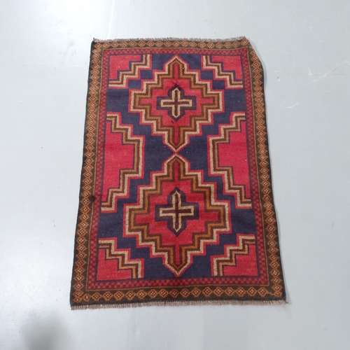 2308 - A red ground Baluchi rug, 114x76cm.