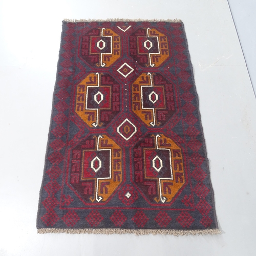 2310 - A red ground Baluchi rug, 140x86cm.