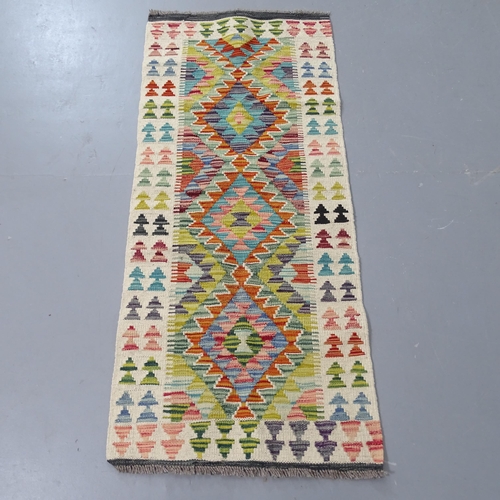 2312 - A cream ground Kilim rug, 140x63cm.