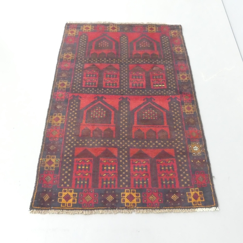 2317 - A red-ground Persian design rug. 135x90cm.