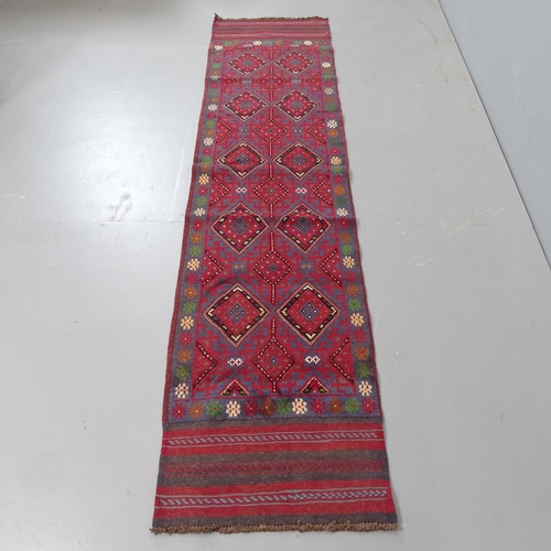 2318 - A red ground Meshwani runner, 247x56cm.