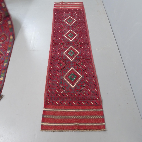 2319 - A red ground meshwani runner, 242x58cm.