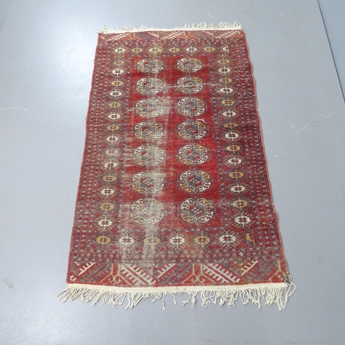 2324 - A red ground Afghan rug, 154x96cm.