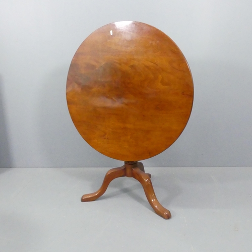 2274 - A mahogany circular tilt-top table, on turned central column with tripod base. 88x72cm.