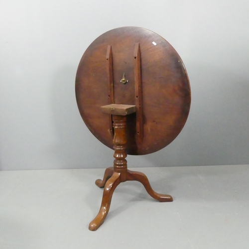 2274 - A mahogany circular tilt-top table, on turned central column with tripod base. 88x72cm.