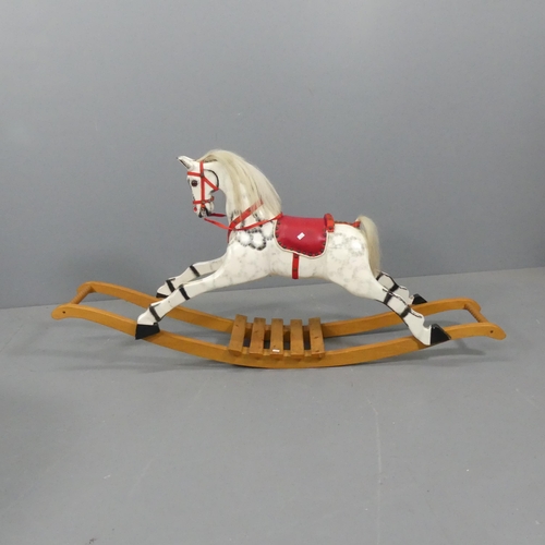 2281 - A painted wooden rocking horse. 147x70x33cm.