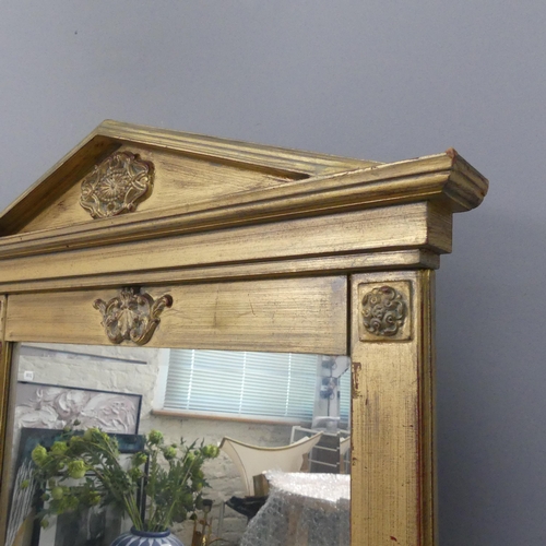 2295 - A French empire stile gilt-painted wall mirror with applied carved decoration. 81x128cm.