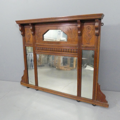 2297 - An oak-framed over-mantel mirror, with carved decoration. 109x82cm.