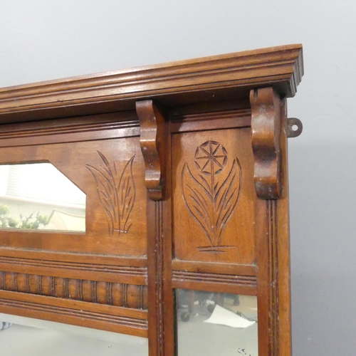 2297 - An oak-framed over-mantel mirror, with carved decoration. 109x82cm.