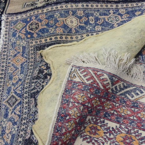 2300 - A blue ground Persian rug, 180x120cm, and a cream ground Afghan rug, 190x120cm. A/F.