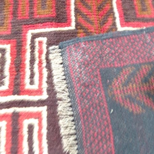 2307 - A red ground Baluchi rug, 140x85cm.