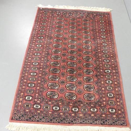 2338 - A red-ground Afghan rug. 182x125cm.