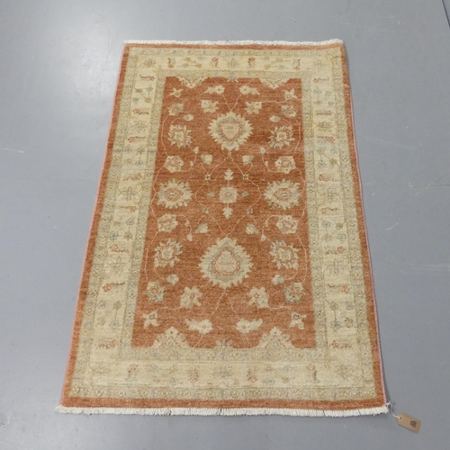 2339 - A modern cream ground Persian design rug. 145x98cm.