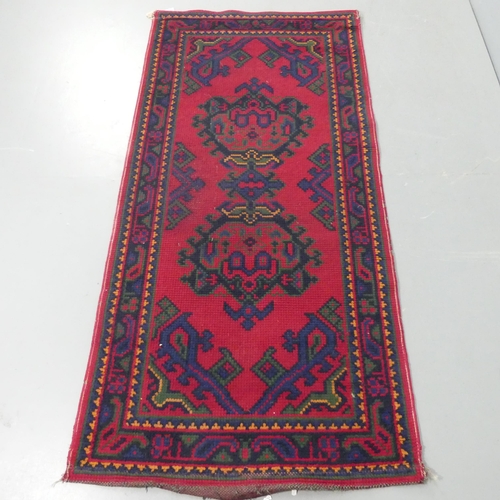 2342 - A red-ground tufted wool Turkoman rug. 188x91cm.