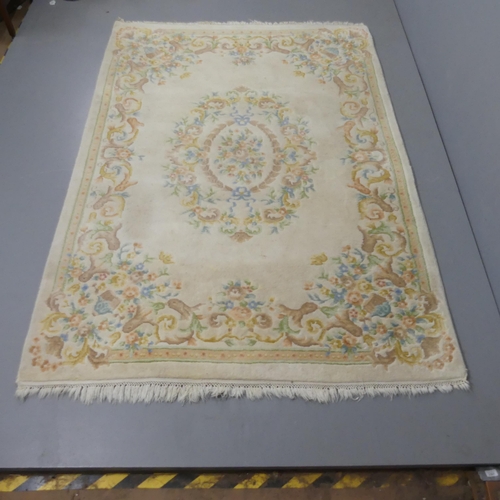 2343 - An Indian cream-ground carpet with floral decoration. 235x162cm.