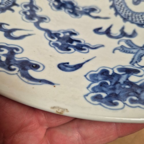 984 - A Chinese blue and white charger, with dragon decoration, diameter 37cm, with Qianlong? blue charact... 