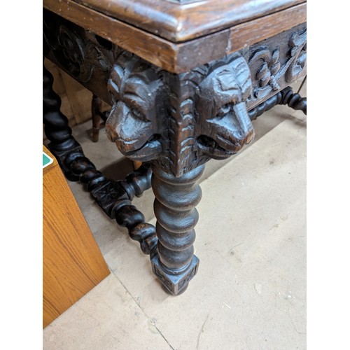 2369 - A 19th century French oak draw-leaf table, with applied carved lion mask and acanthus leaf decoratio... 