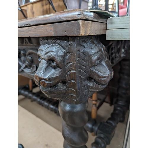 2369 - A 19th century French oak draw-leaf table, with applied carved lion mask and acanthus leaf decoratio... 