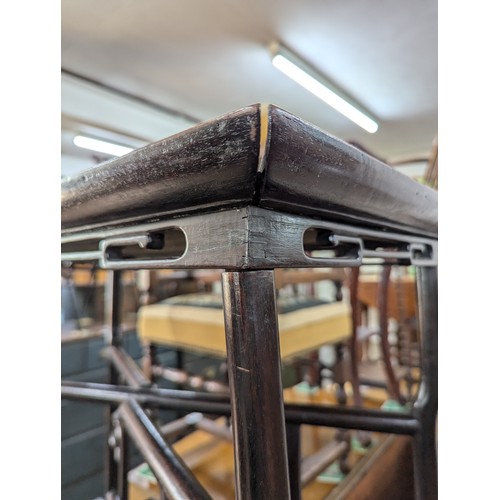 2299 - A Chinese mahogany rectangular tray top table on folding base, 74x66x39cm.