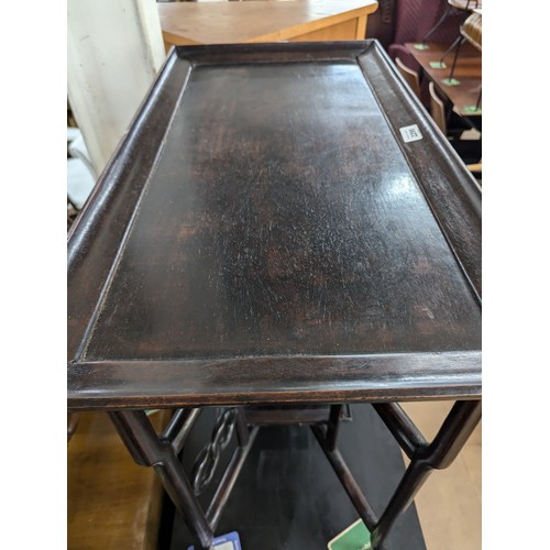 2299 - A Chinese mahogany rectangular tray top table on folding base, 74x66x39cm.