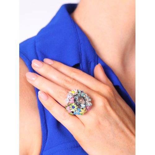 19 - CHRISTIAN DIOR - An Aquamarine and Enamel 'Diorette' Ring,

set with an oval mixed-cut aquamarine wi... 