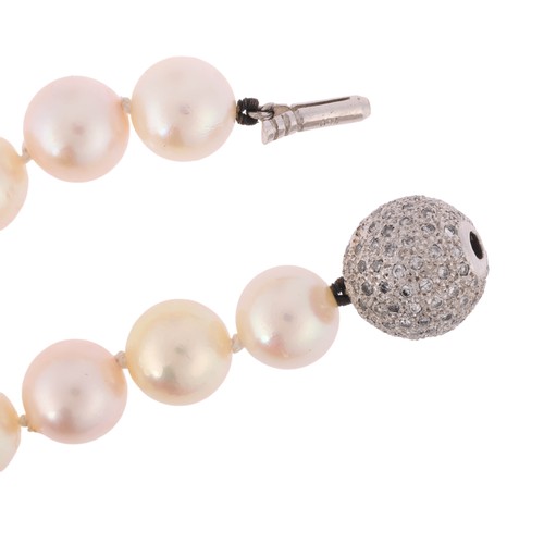 67 - A Pearl and Diamond Necklace,

comprising a single row of 9mm pearls, the sphere clasp pave set with... 