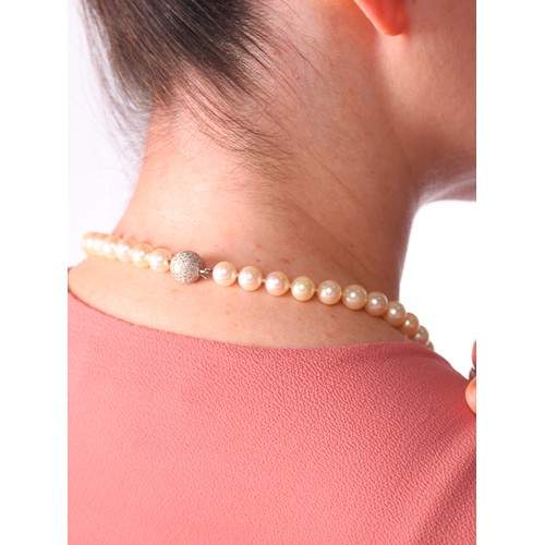 67 - A Pearl and Diamond Necklace,

comprising a single row of 9mm pearls, the sphere clasp pave set with... 