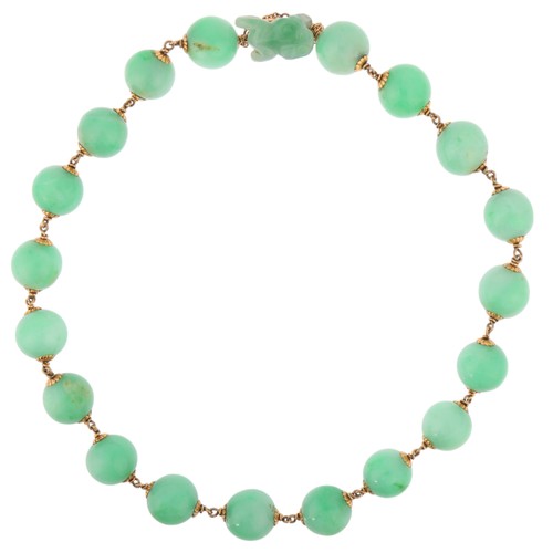 45 - A Jadeite Jade Necklace,

comprising one row of even sized jade beads measuring 13mm, interspaced wi... 