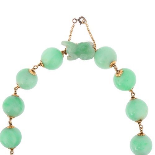 45 - A Jadeite Jade Necklace,

comprising one row of even sized jade beads measuring 13mm, interspaced wi... 