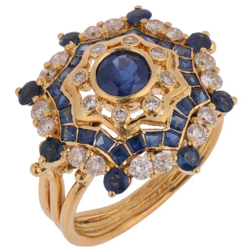 56 - A Sapphire and Diamond Ring,

of flowerhead design set with round and square cut sapphires interspac... 